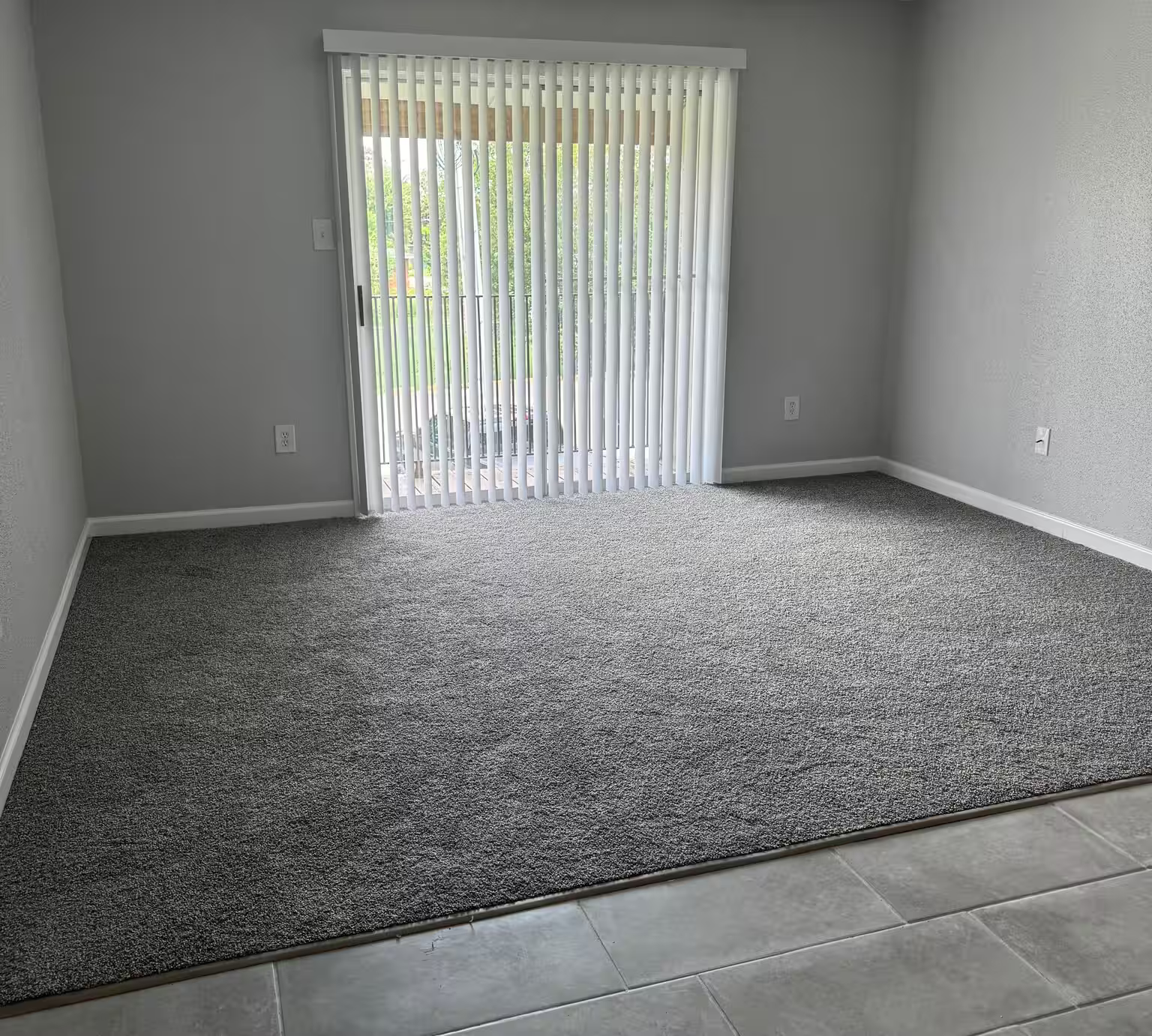 A living room at Cypress Cove with patio doors